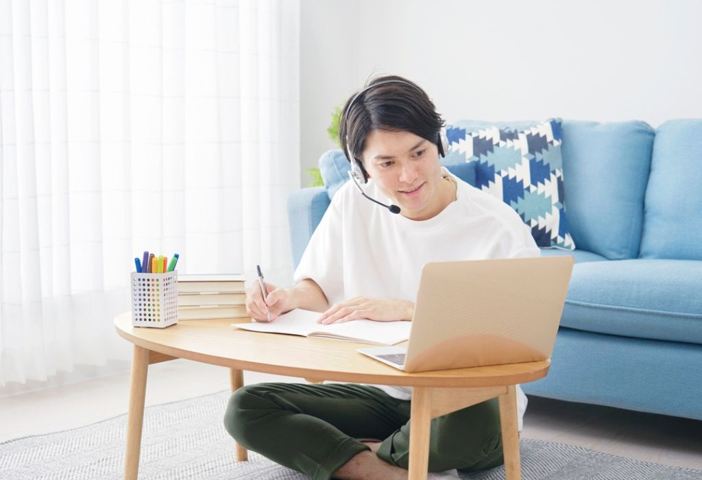 Asian man studying online at home
